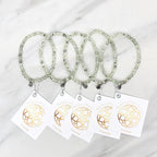 Three beaded bracelets on white cards with 'Prehnite' and 'Bestie Bundles' text on a marble background. valentines gifts galentines day