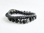 Set of black beaded bracelets on a white background