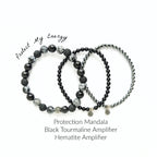 Set of black beaded bracelets with text on a white background