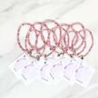 Three pink rhodonite beaded bracelets on cards with 'Rhodonite' text, branded 'Rhodonite Bestie Bundles' on a marble background. valentine gifts galentines day