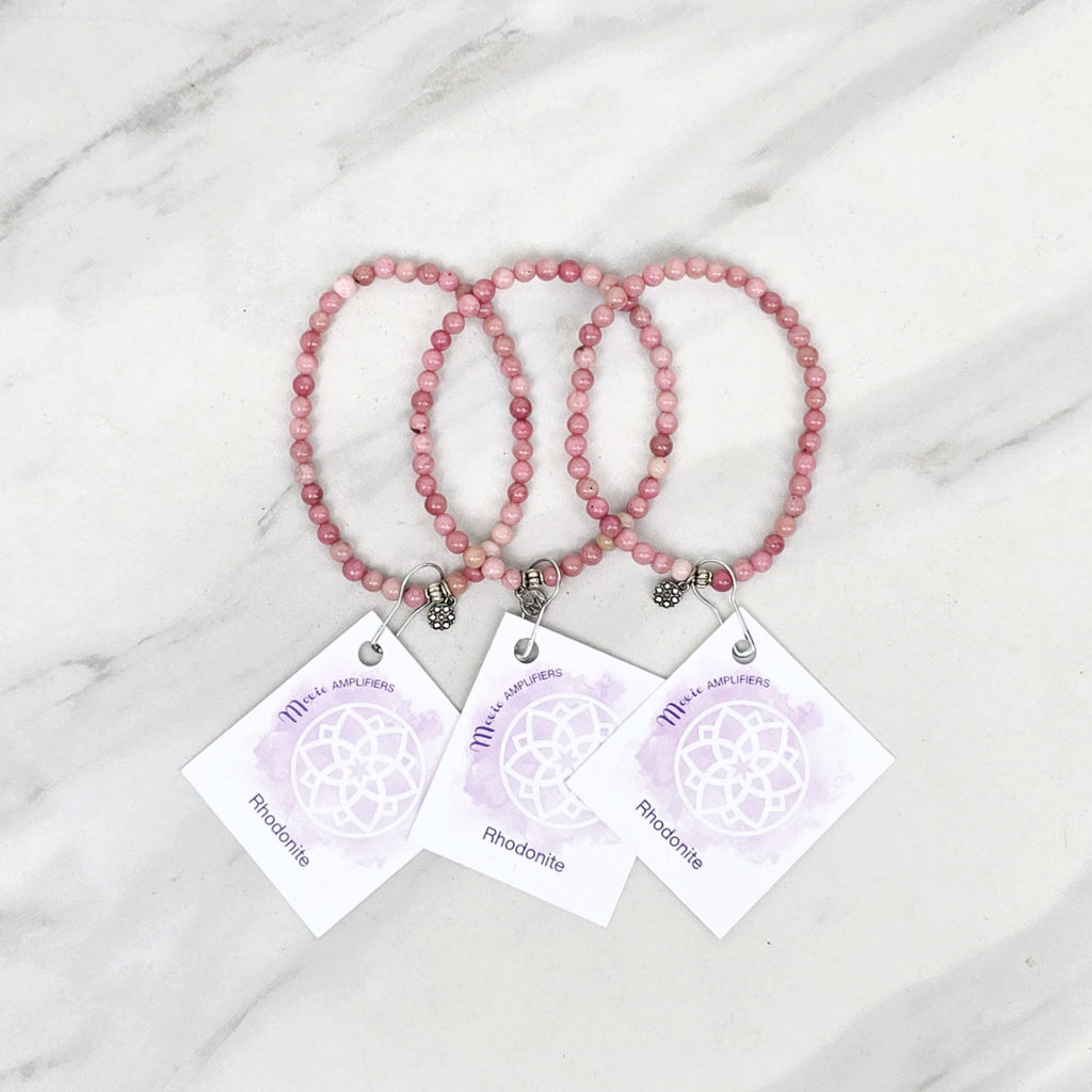 Three pink rhodonite beaded bracelets on cards with 'Rhodonite' text, branded 'Rhodonite Bestie Bundles' on a marble background. valentine gifts galentines day