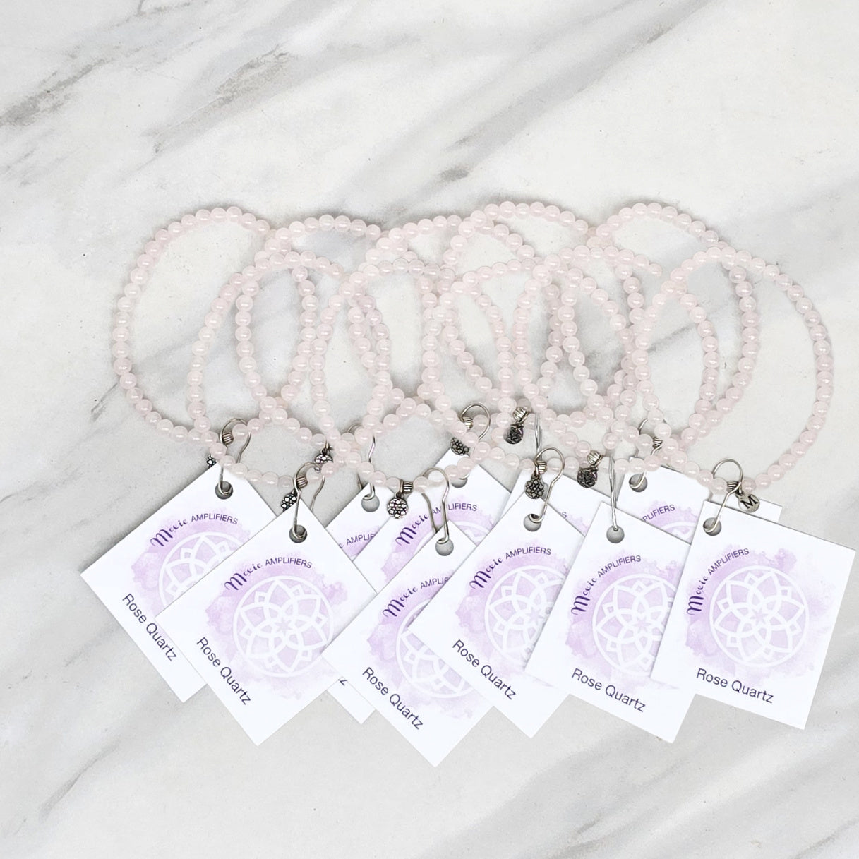 rose quartz bracelets with matching cards on a marble surface, branded 'Rose Quartz Bestie Bundles'. valentine gift galentines day