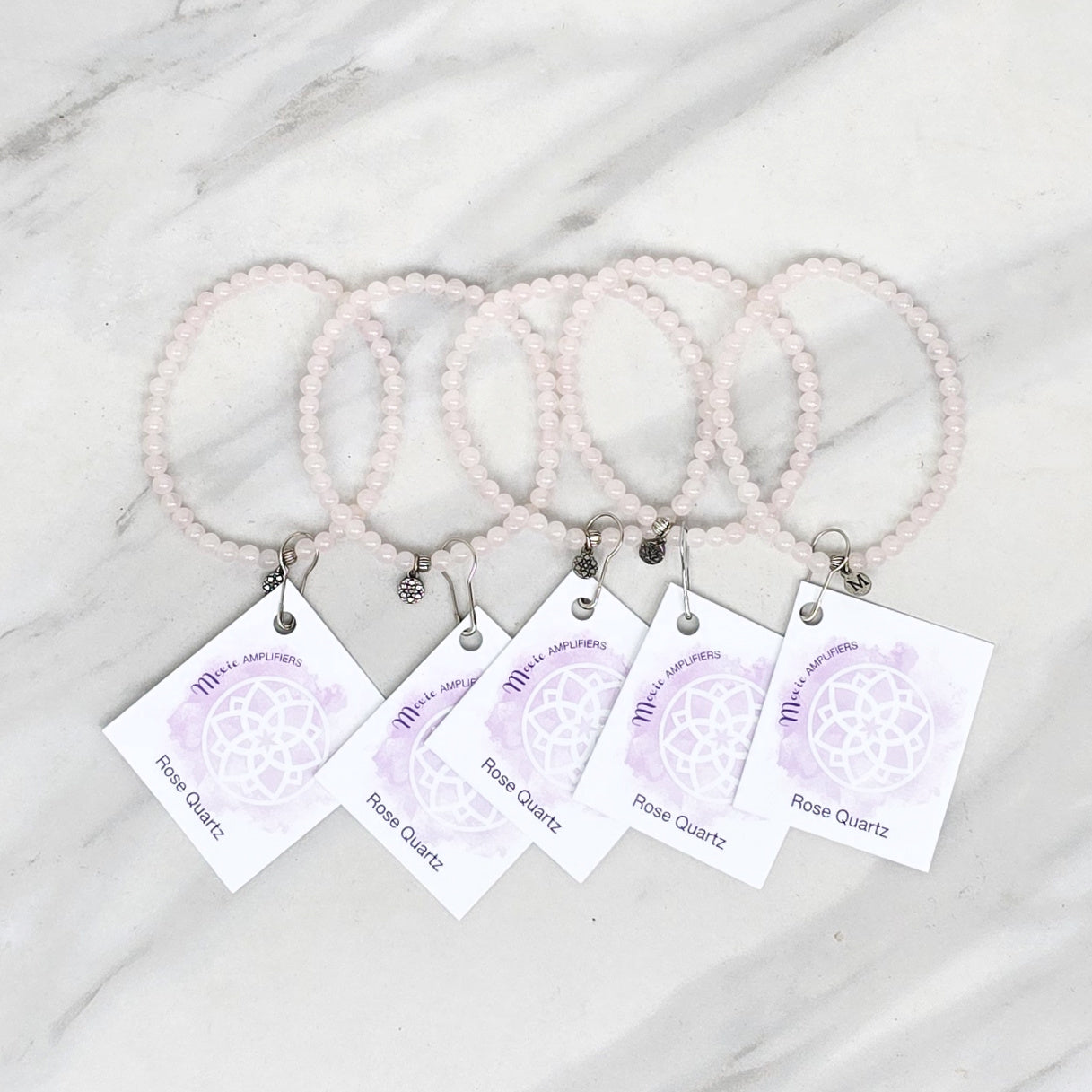 rose quartz bracelets with matching cards on a marble surface, branded 'Rose Quartz Bestie Bundles'. valentine gift galentines day