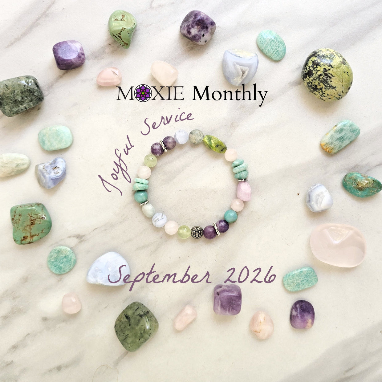 A beaded bracelet with pastel and earthy tones is arranged on a light marble surface, surrounded by polished crystals. Text overlays read 'MOXIE Monthly', 'Joyful Service', and 'September 2026'.