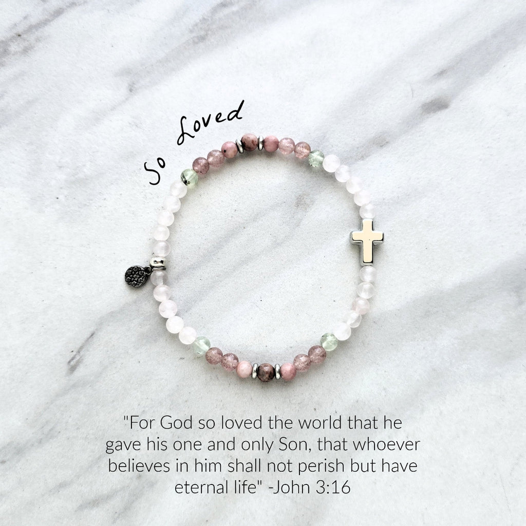Beaded bracelet with a silver cross charm on a marble surface, featuring John 3:16 Christian bracelet love