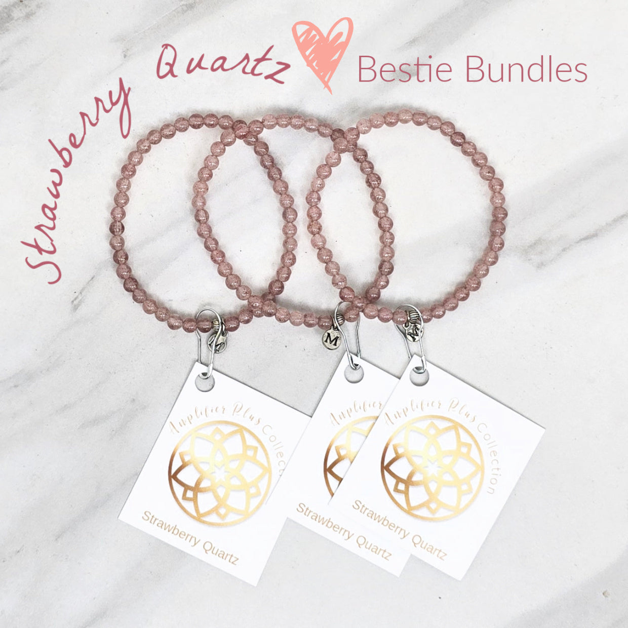 Two strawberry quartz beaded bracelets with matching tags on a marble surface. valentines day galentines gifts
