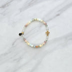 Beaded bracelet with a cross charm on a marble surface, featuring a religious quote. psalms 139:13-14 Christian bracelet wonderfully made