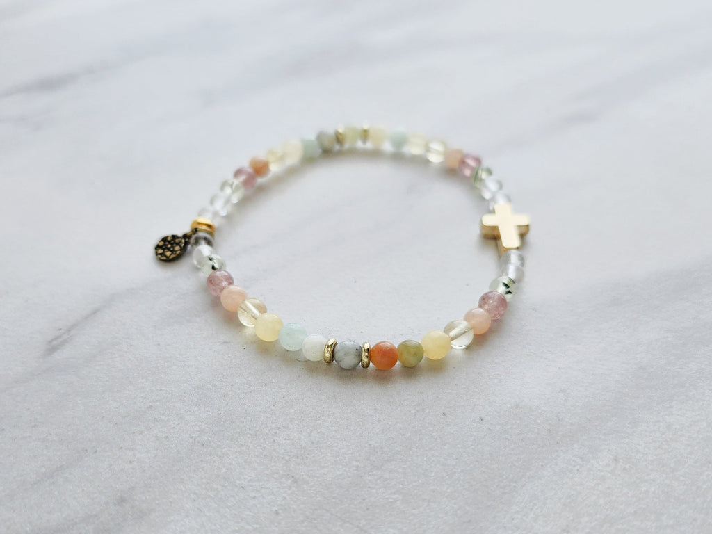 Beaded bracelet with a cross charm on a marble surface, featuring a religious quote. psalms 139:13-14 Christian bracelet wonderfully made