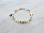Beaded bracelet with a cross charm on a marble surface, featuring a religious quote. psalms 139:13-14 Christian bracelet wonderfully made