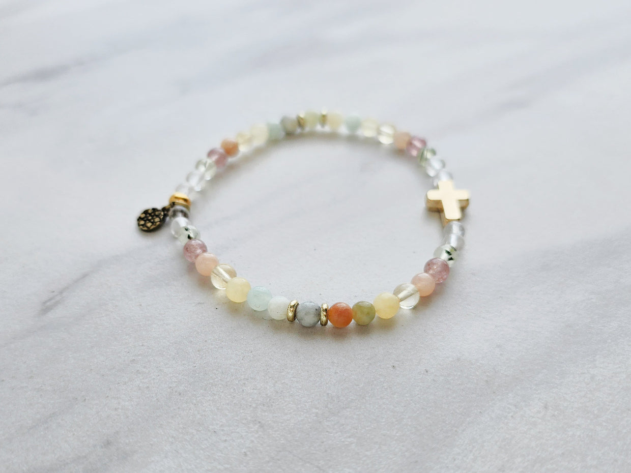 Beaded bracelet with a cross charm on a marble surface, featuring a religious quote. psalms 139:13-14 Christian bracelet wonderfully made