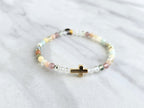 Beaded bracelet with a gold cross charm on a marble surface, featuring a religious quote. psalms 139:13-14 Christian bracelet wonderfully made