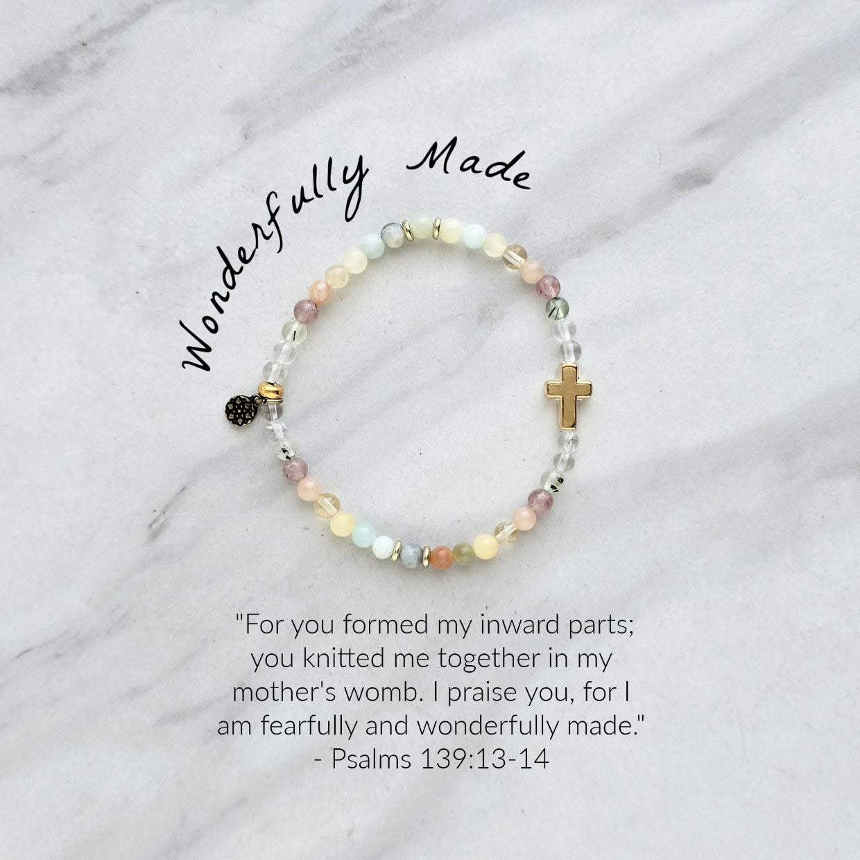 Beaded bracelet with a cross charm on a marble surface, featuring a religious quote. psalms 139:13-14 Christian bracelet wonderfully made