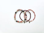 Three beaded bracelets on a white background